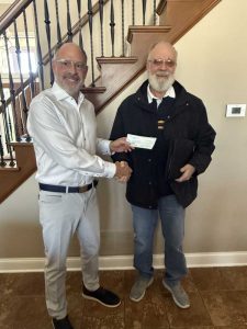 Neil Browne accepts Super Bowl Monday Raffle Proceeds